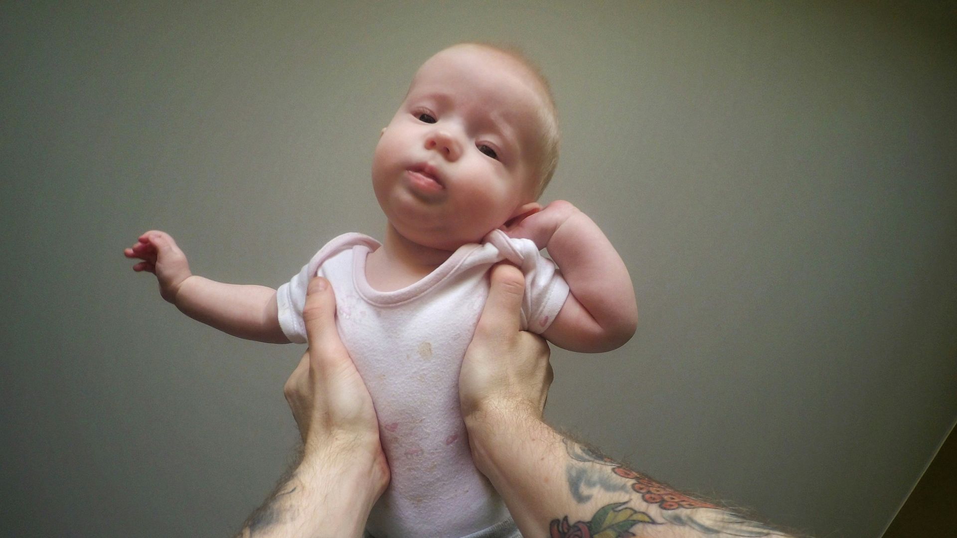 a man holding a baby in his arms