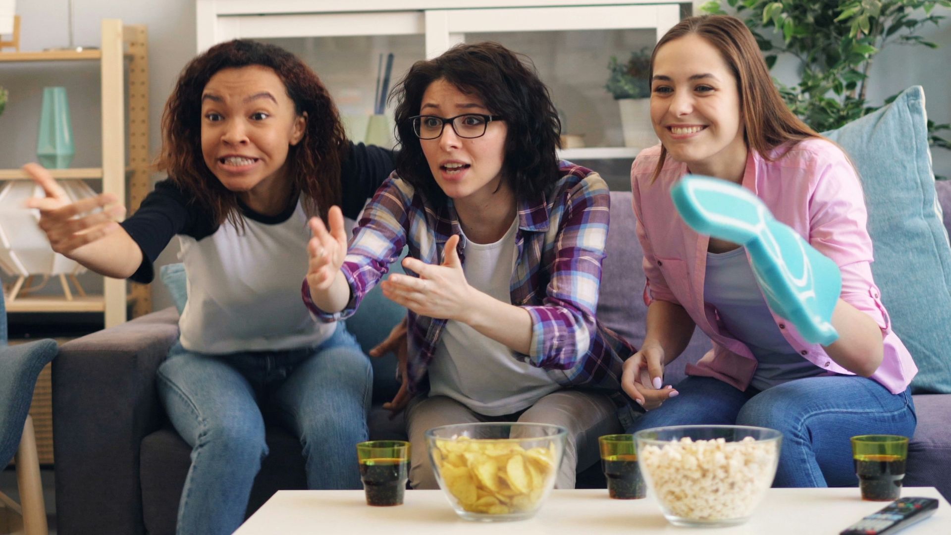 a group of women sitting on top of a couch