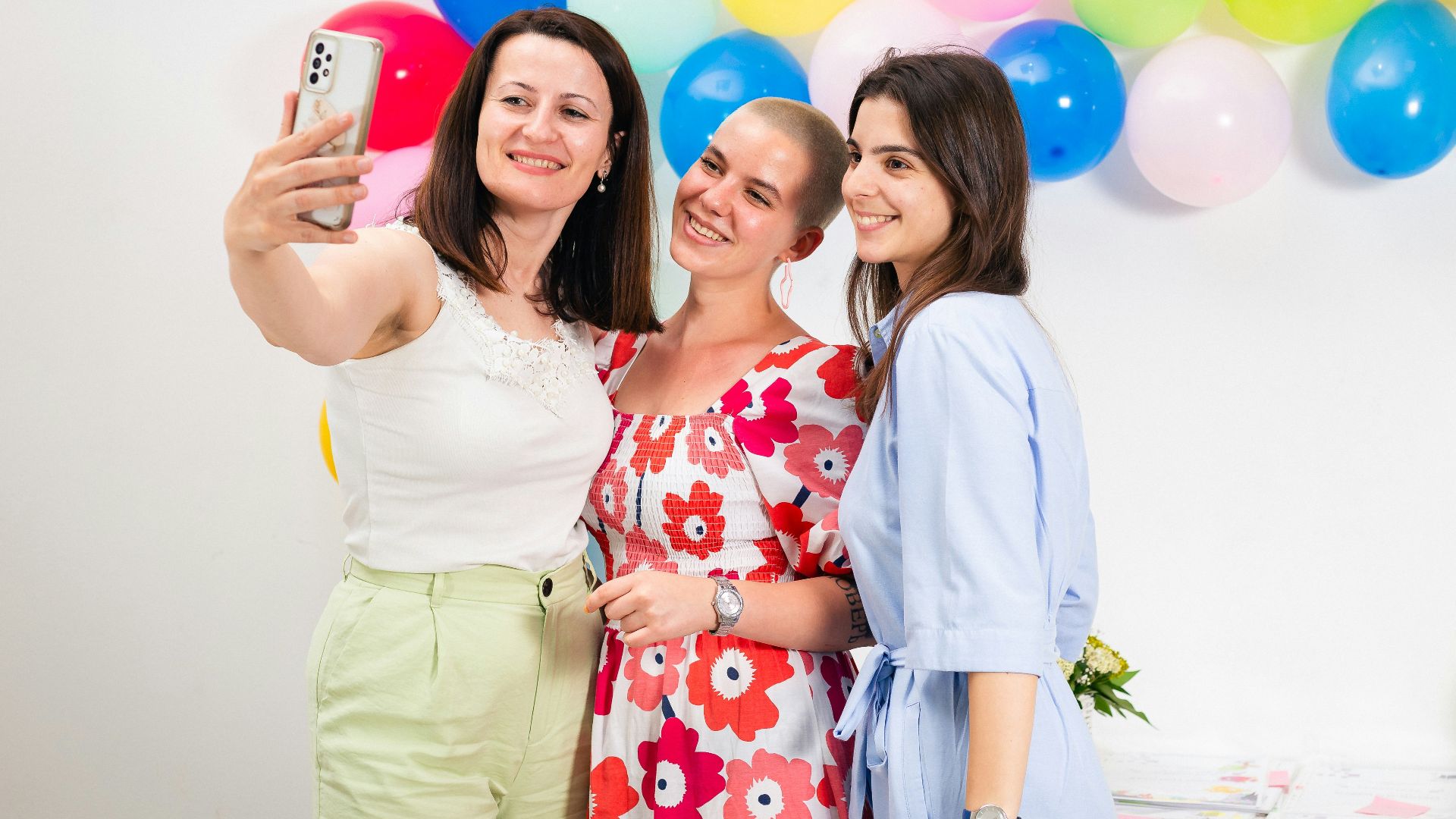 two women taking a picture with a cell phone