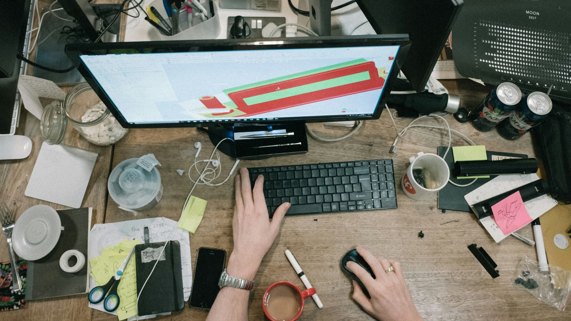 person using computer on brown wooden table