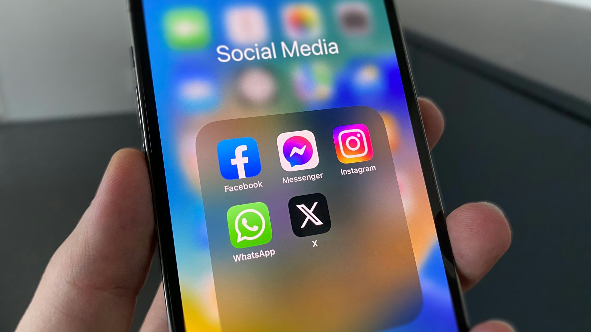 a person holding a cell phone with social media on the screen