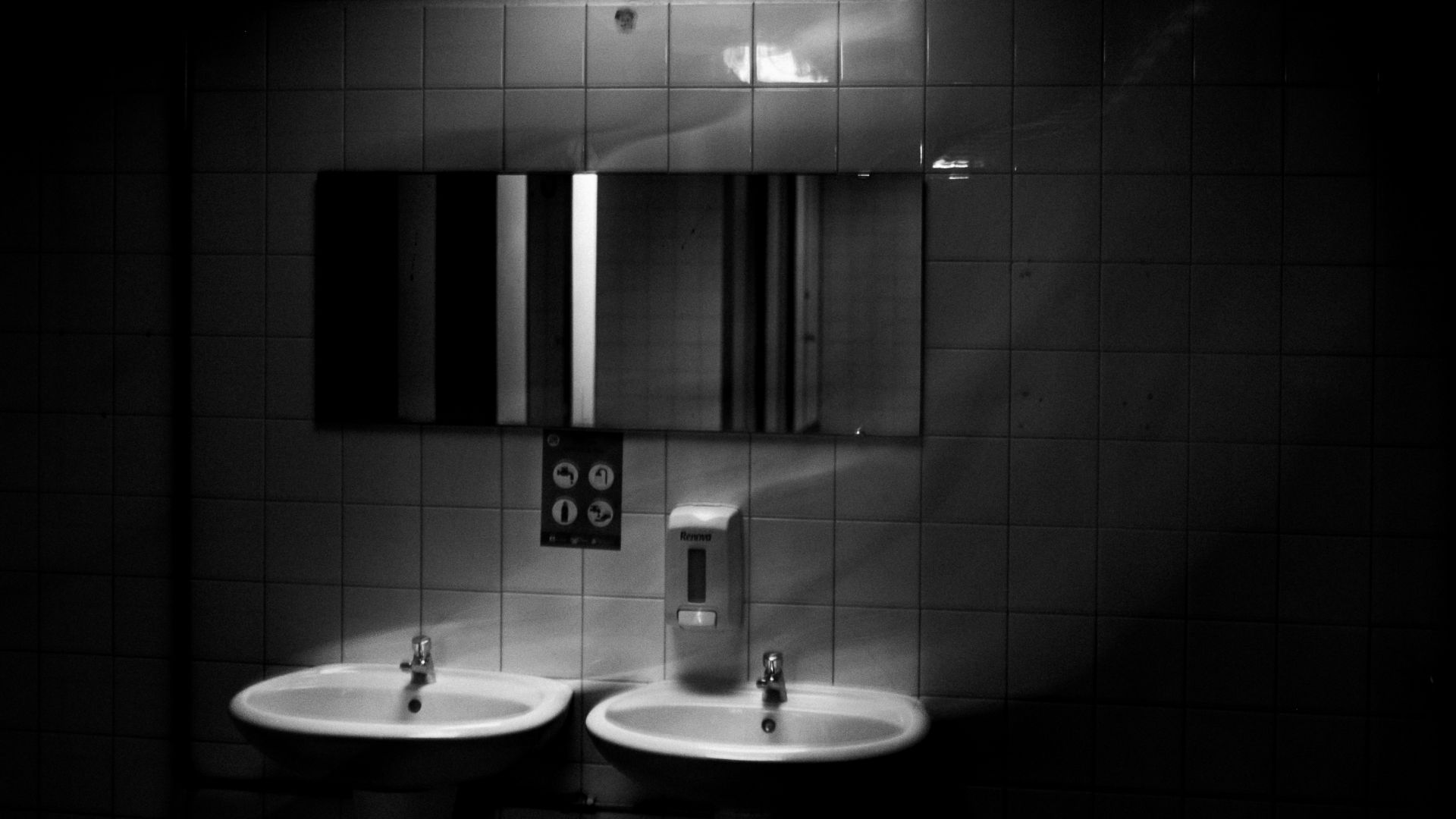A bathroom with two sinks and a mirror