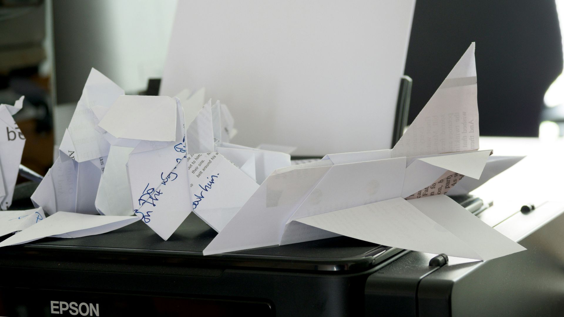 a bunch of papers sitting on top of a printer