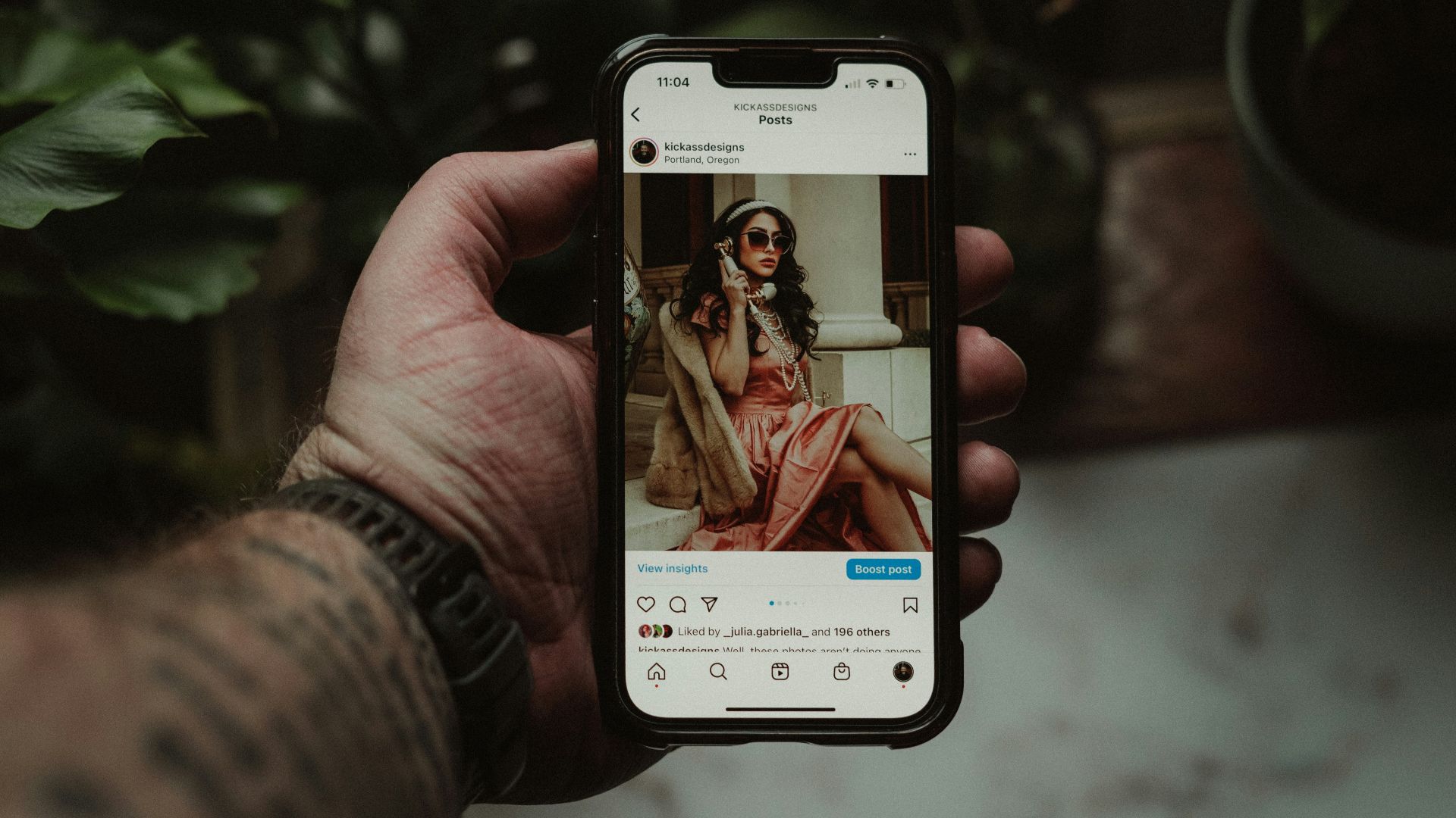 a person holding a cell phone with a picture of a woman on it