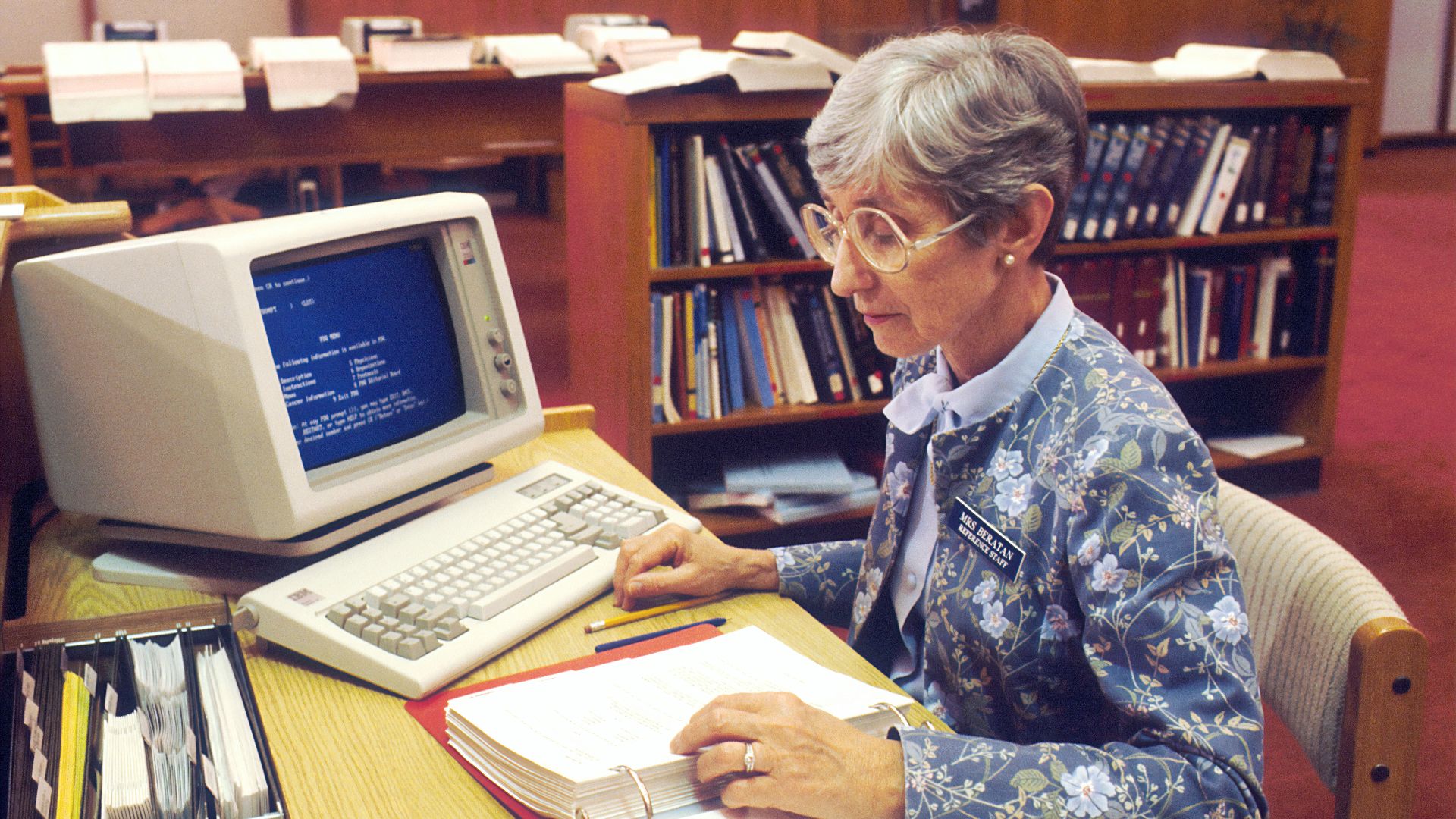 woman sitting at desk with desktop computer