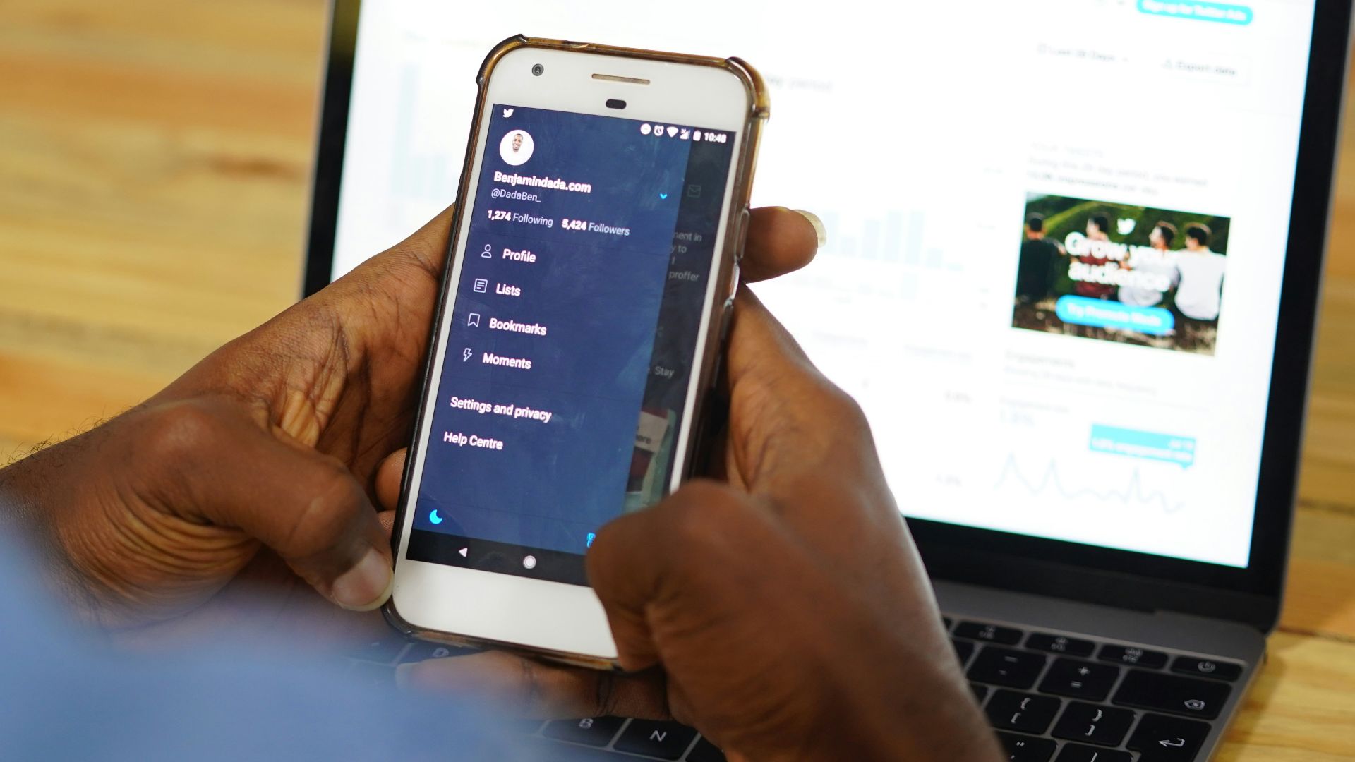 person using a laptop and smartphone