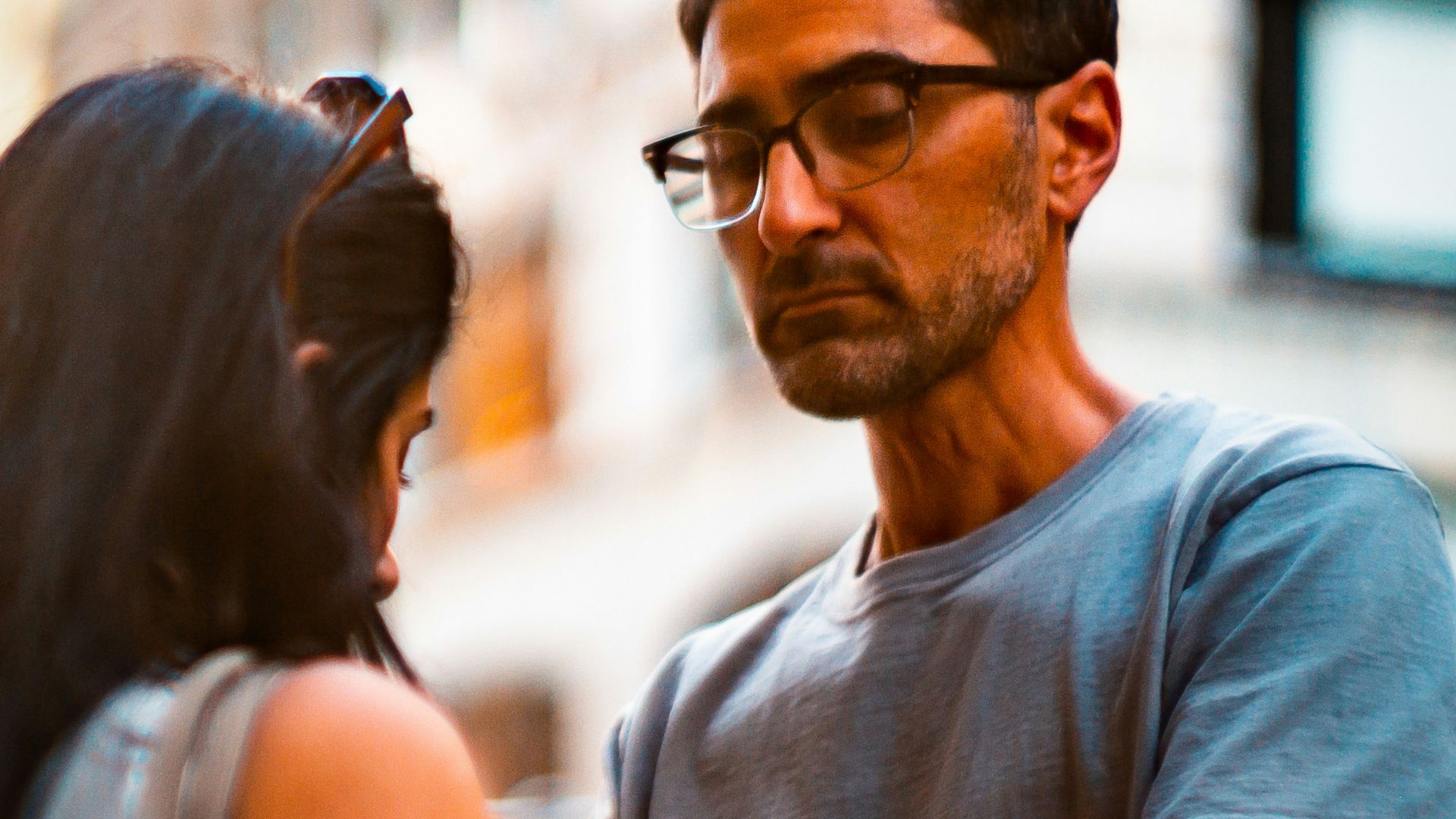 man holding woman's shoulder