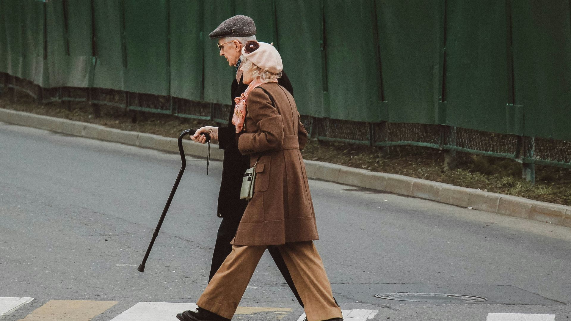 man and woman walking on pedestrian line during daytime