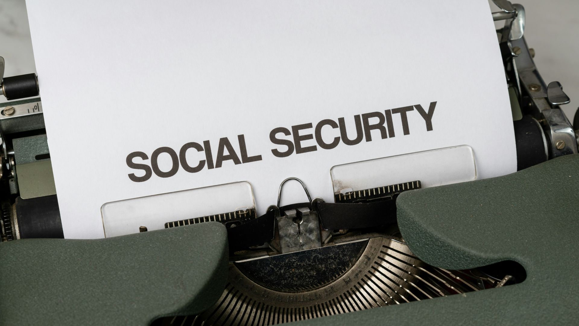 a close up of a typewriter with a paper that says social security