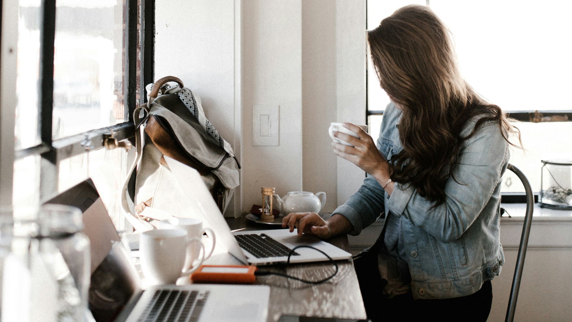 man holding white ceramic teacup