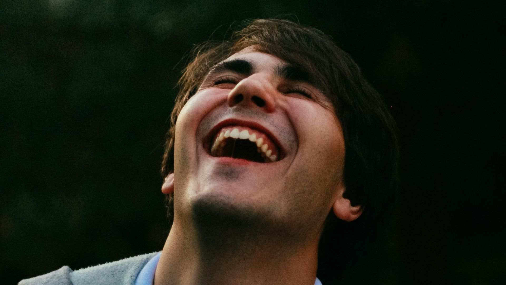 man in gray sweater smiling