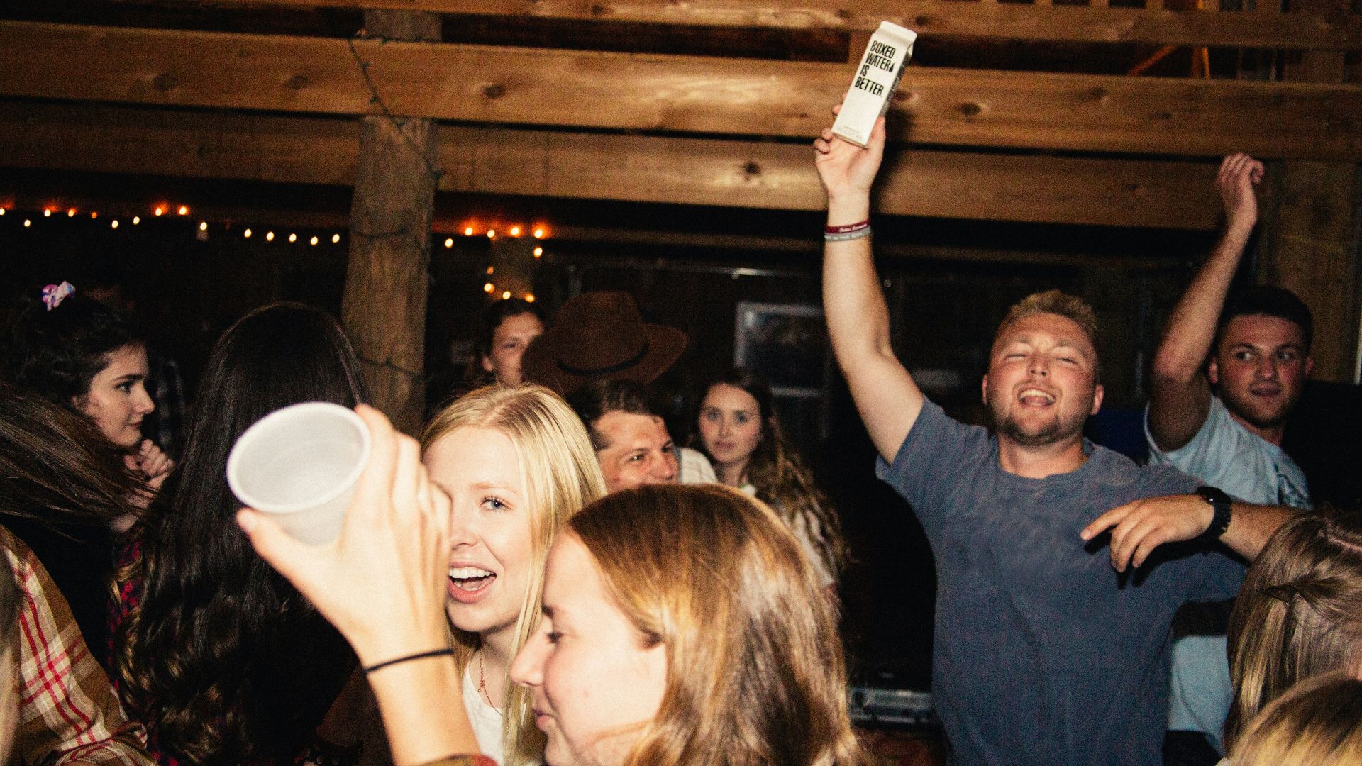 man in black crew neck t-shirt holding white ceramic mug
