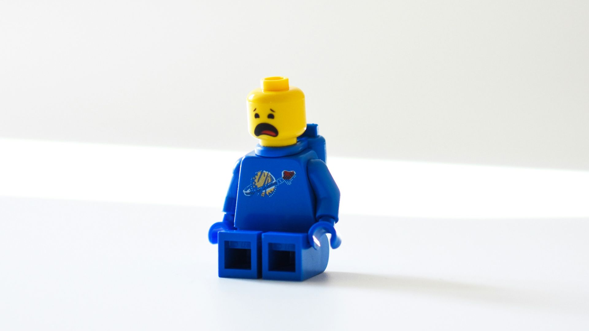 blue lego minifig on white surface