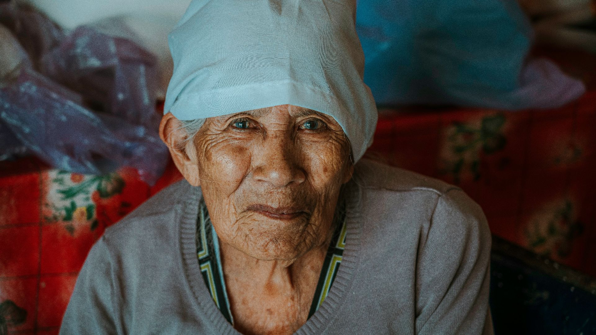 An elderly woman poses for a portrait.