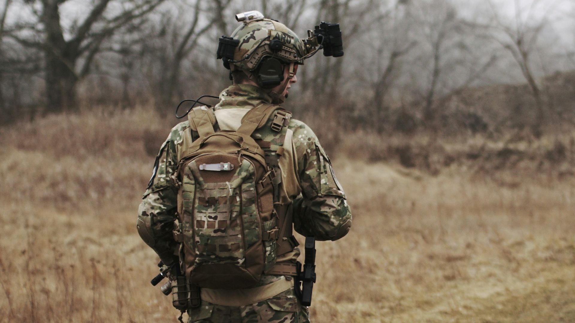man walking on brown grass field