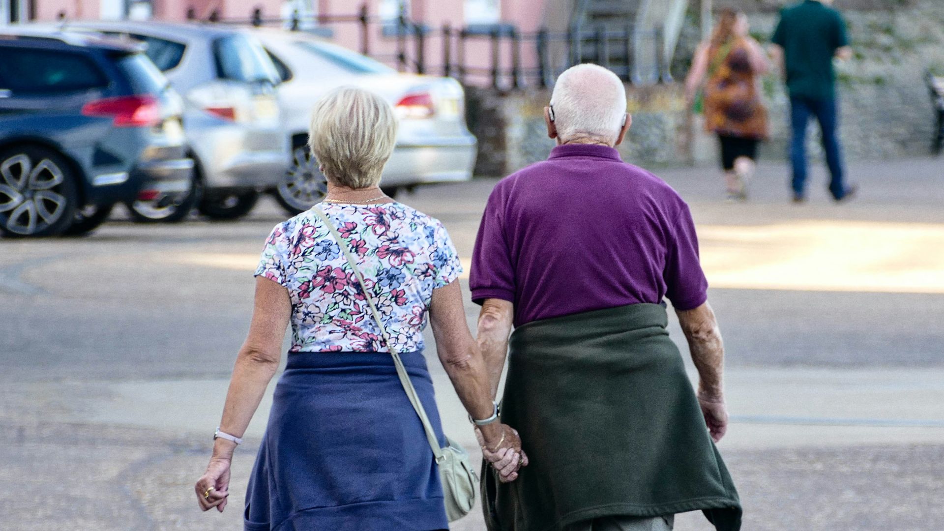 man and woman walking on the street during daytime