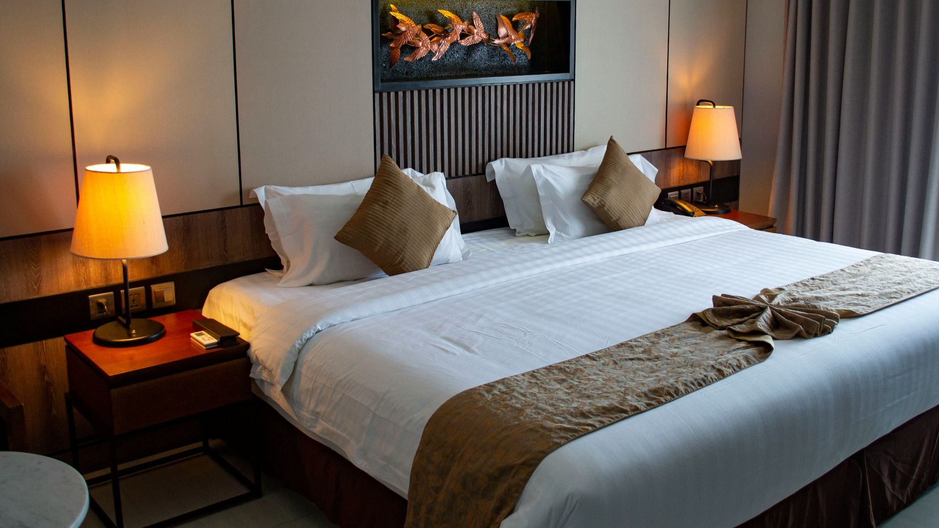 white bed linen with throw pillows