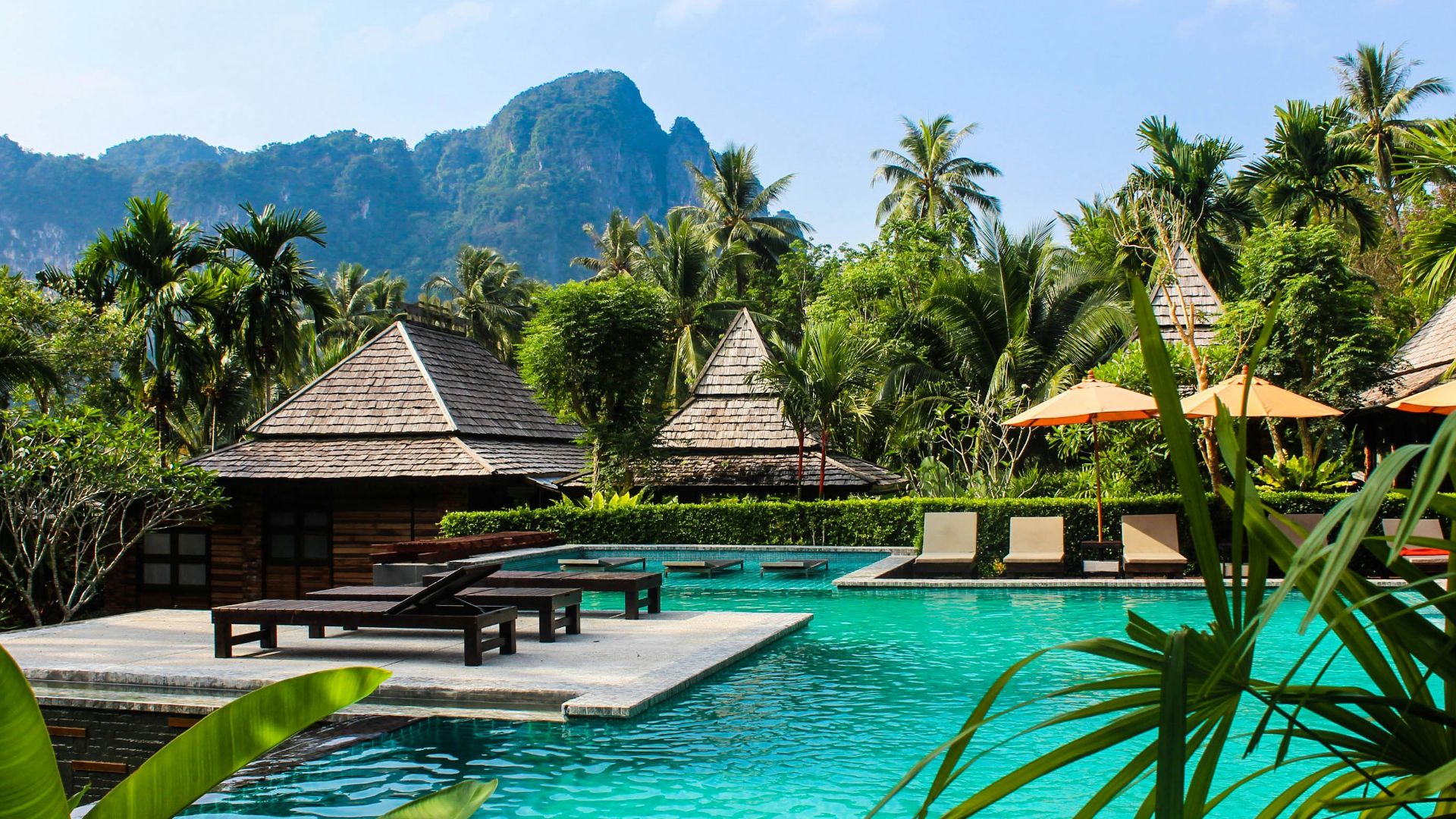 photo of brown bench near swimming pool