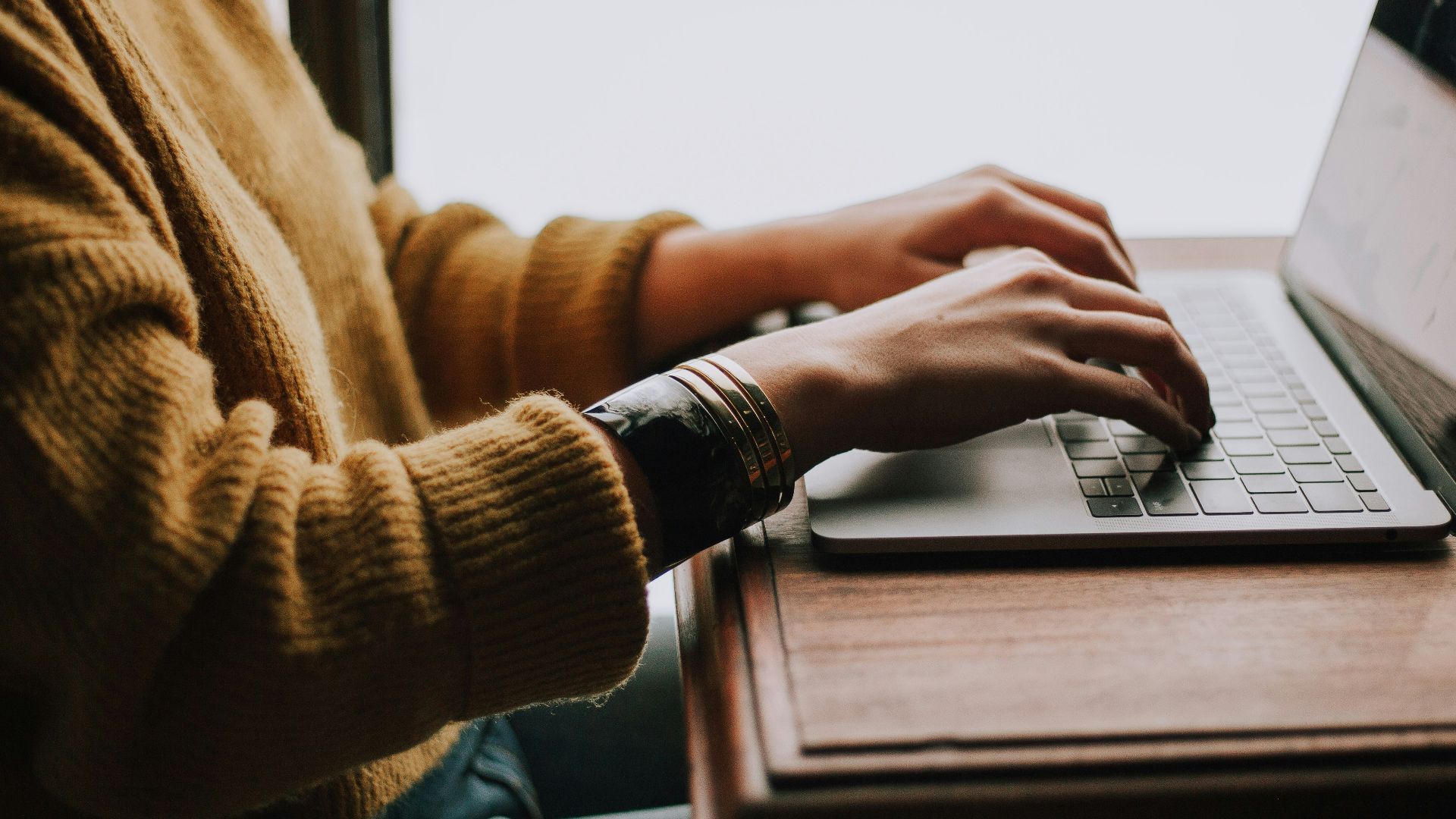 person sitting front of laptop