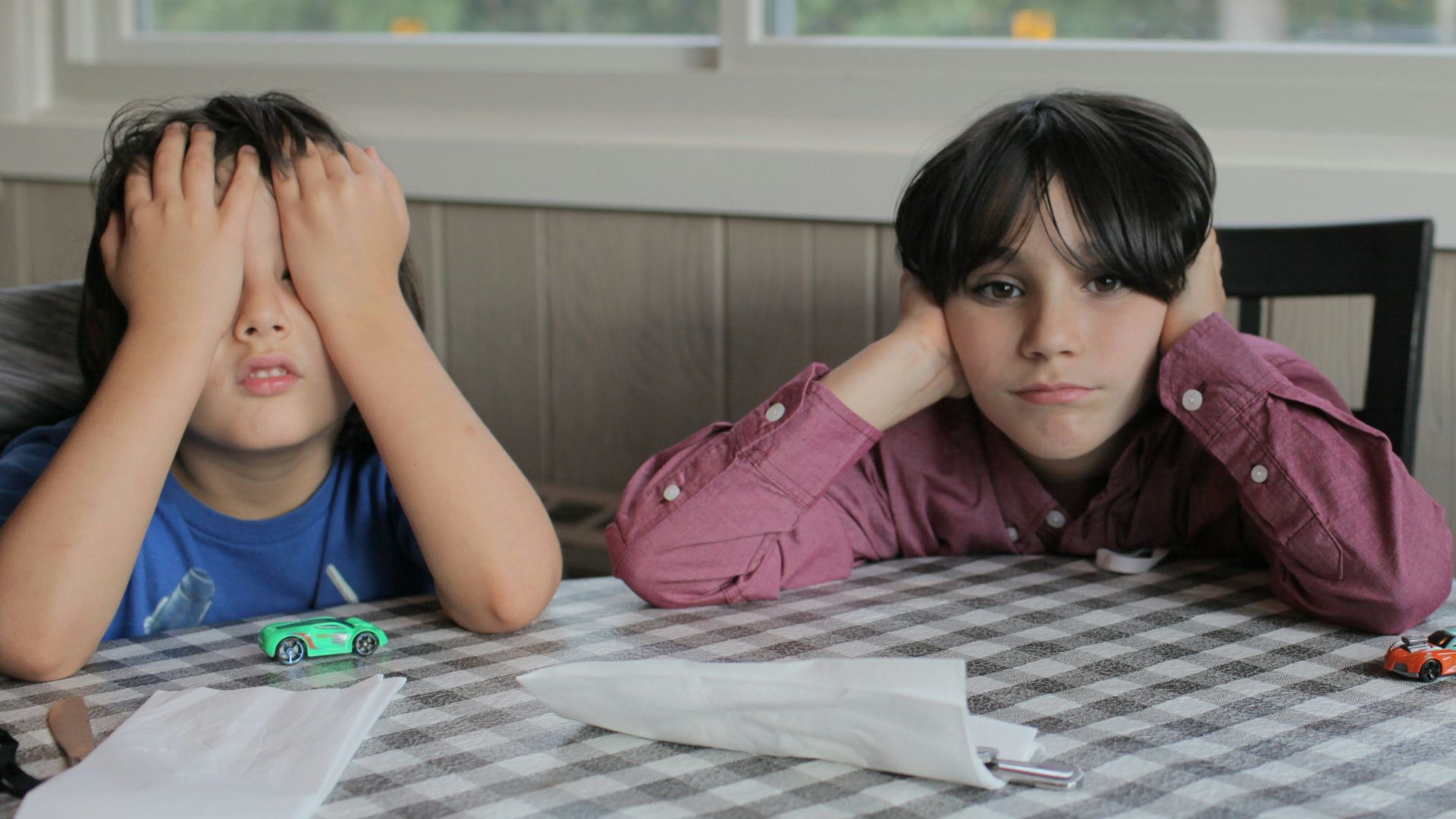 2 women sitting on chair in front of table