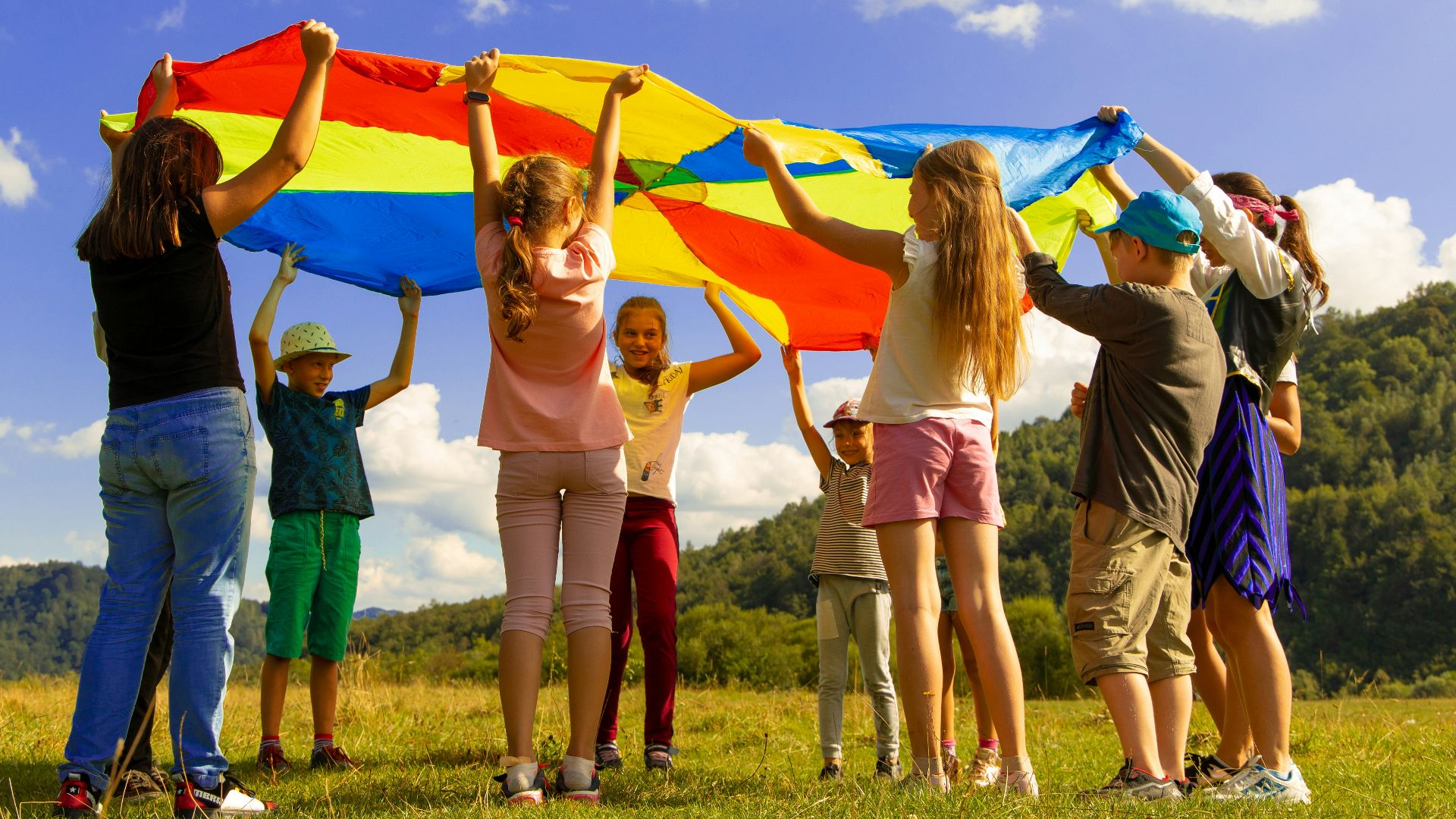 group of women standing on green grass field during daytime