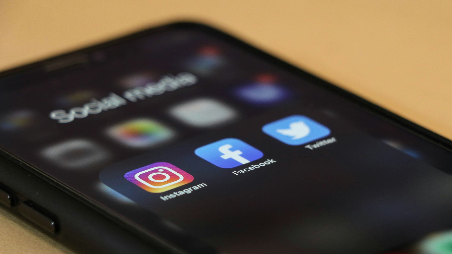 black iphone 4 on brown wooden table