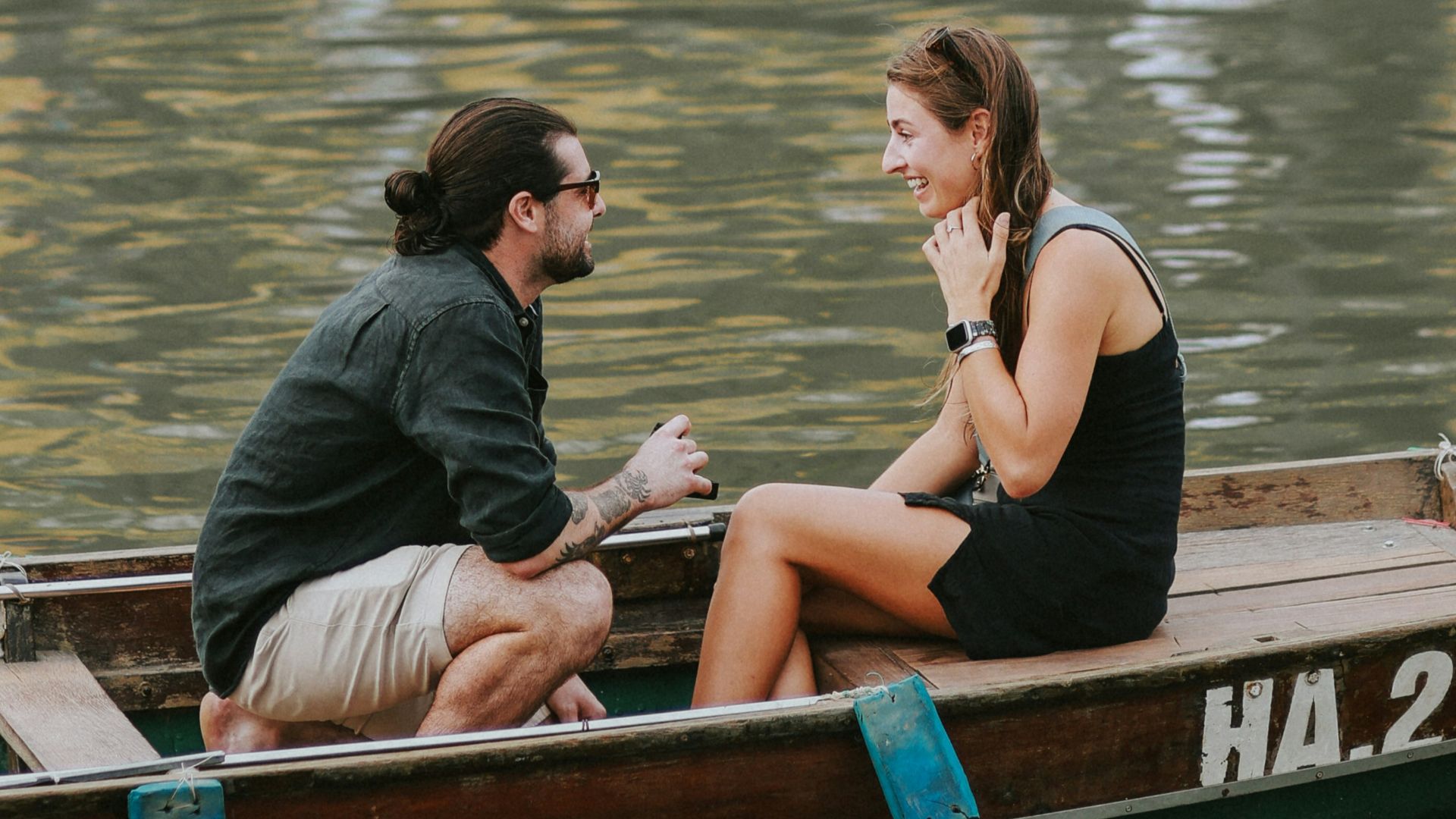 a man and a woman sitting in a small boat