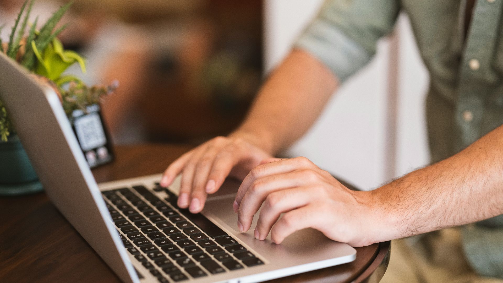 a man typing on a laptop