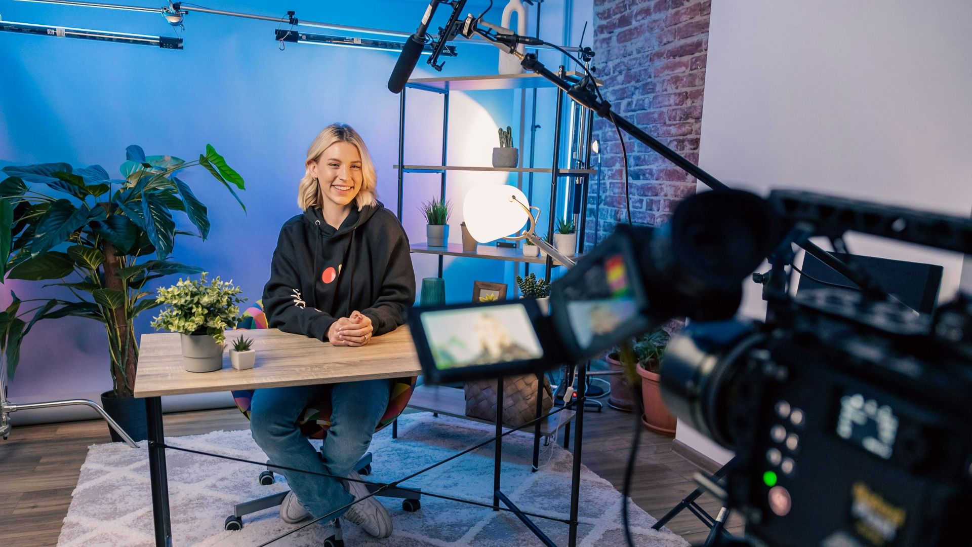 a person sitting at a table with a camera and a camera