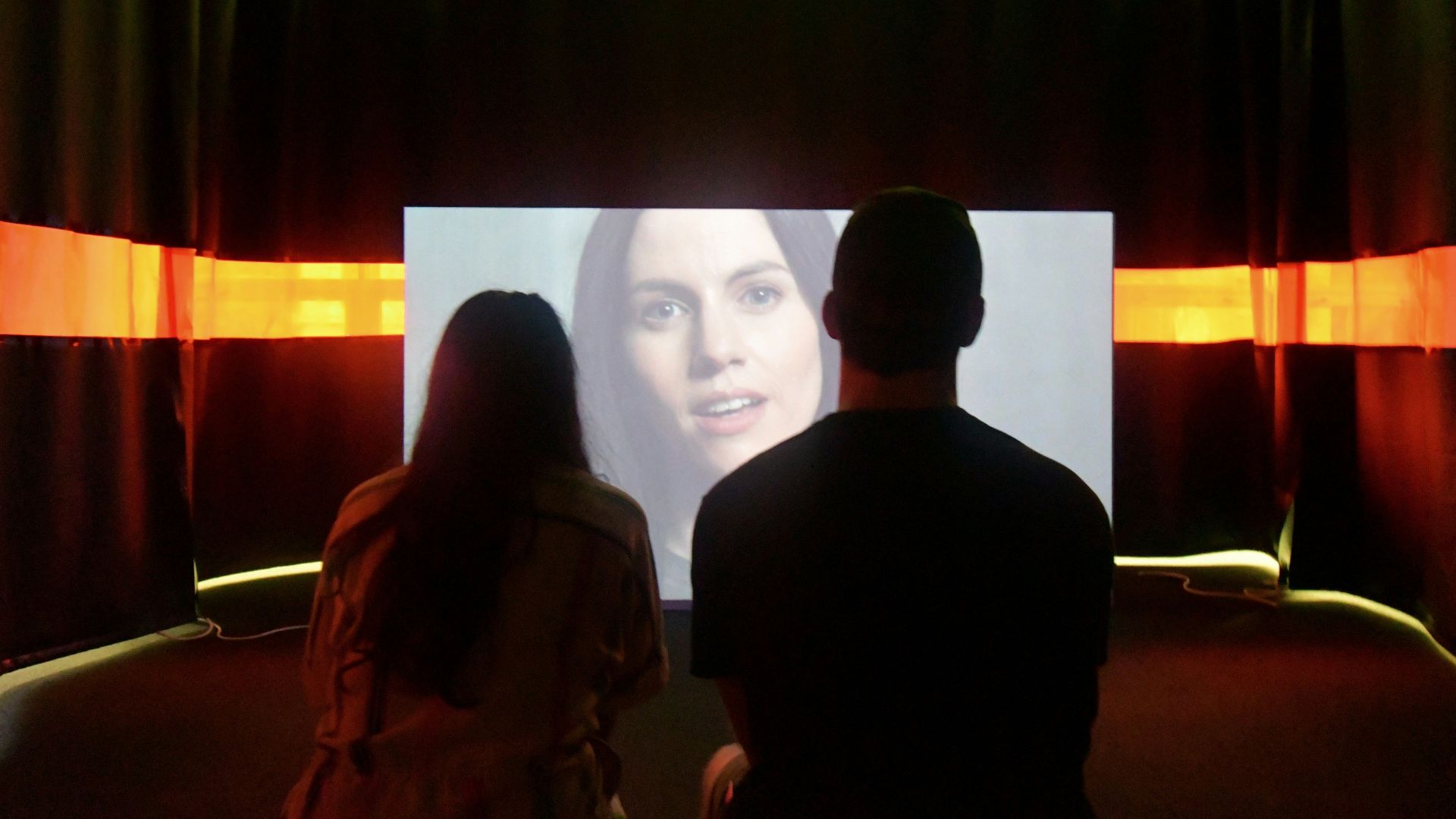 man in black shirt standing beside woman in brown coat