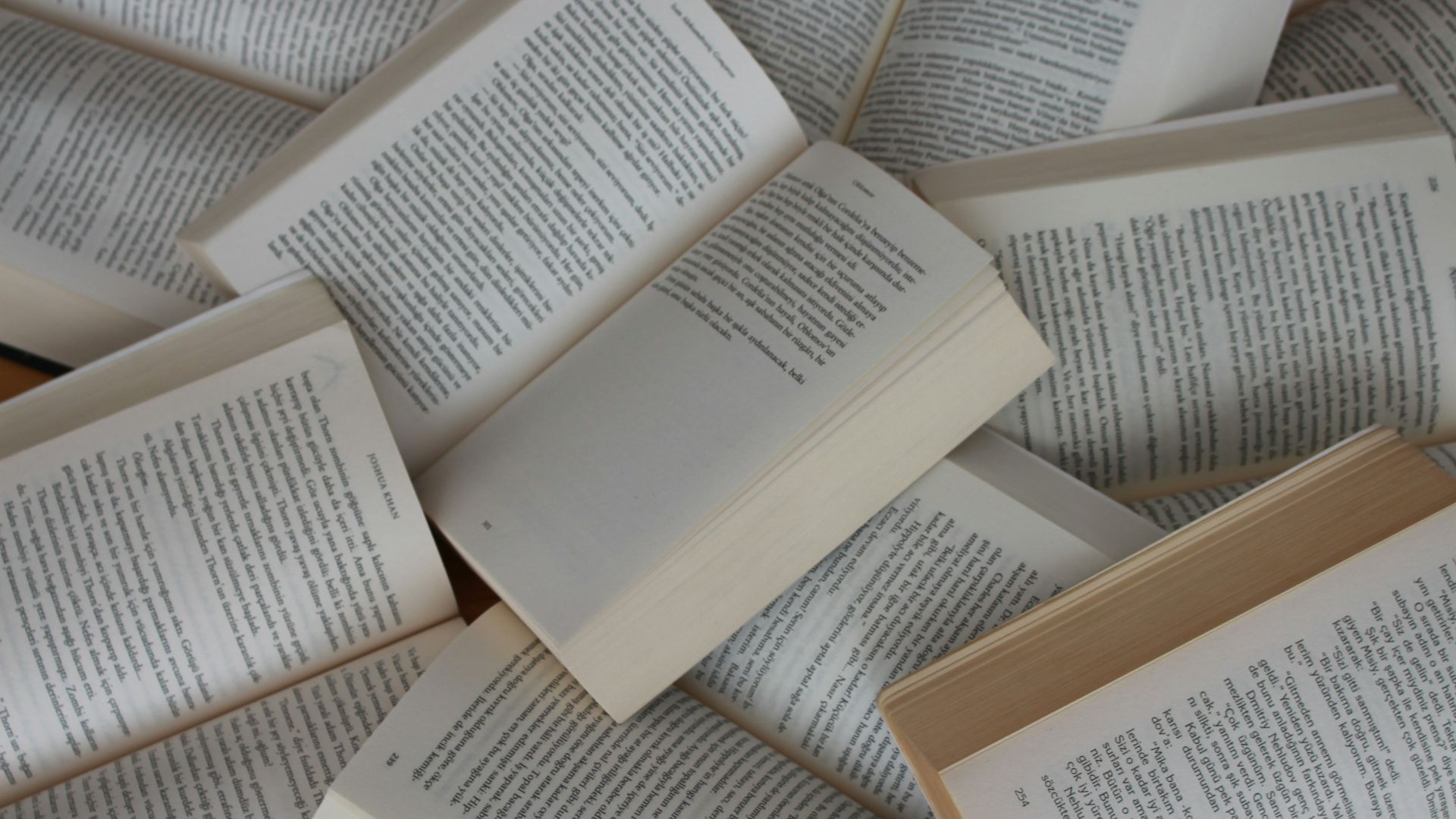 white and brown book on brown woven surface