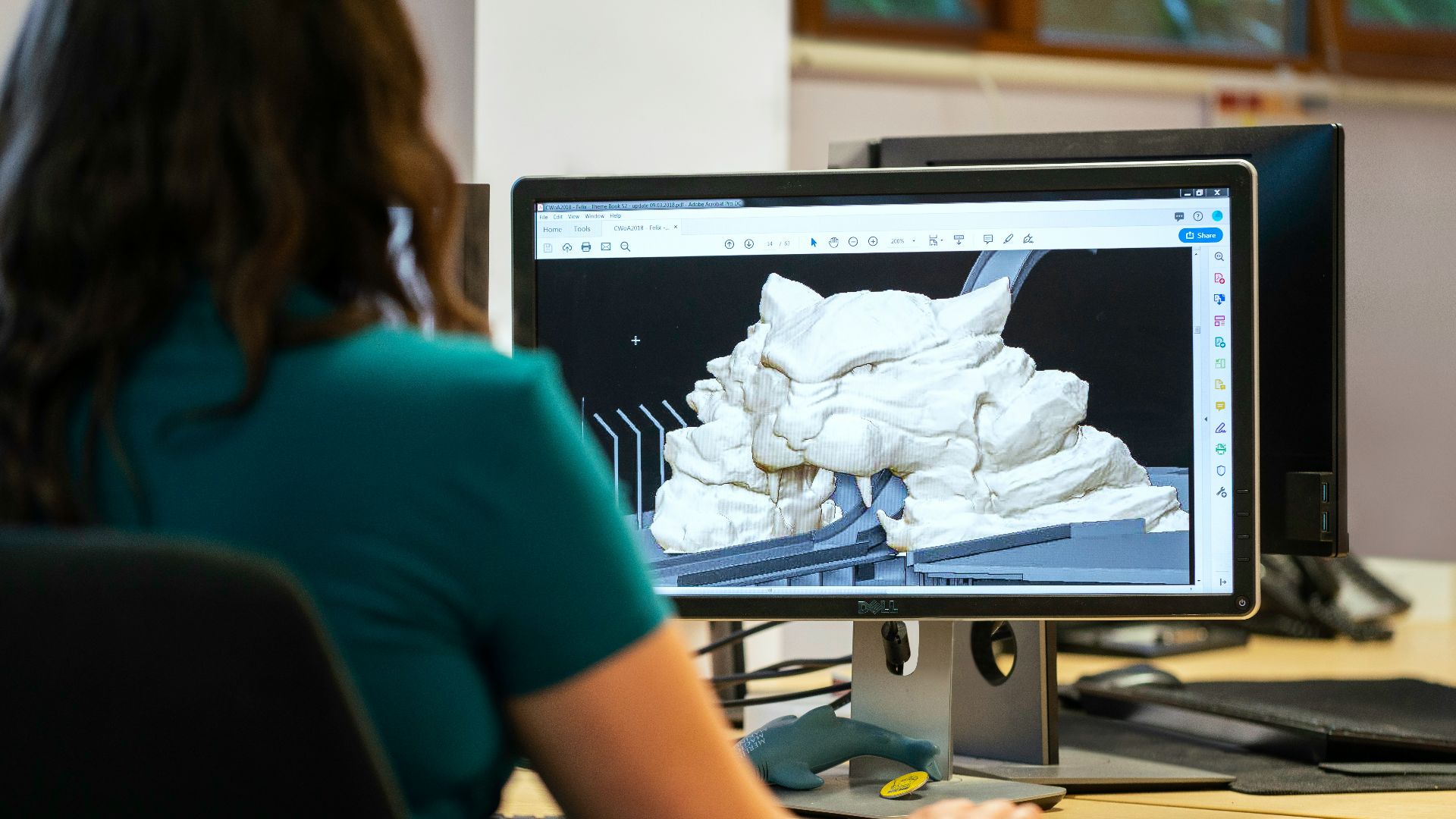 woman in blue t-shirt sitting at the table