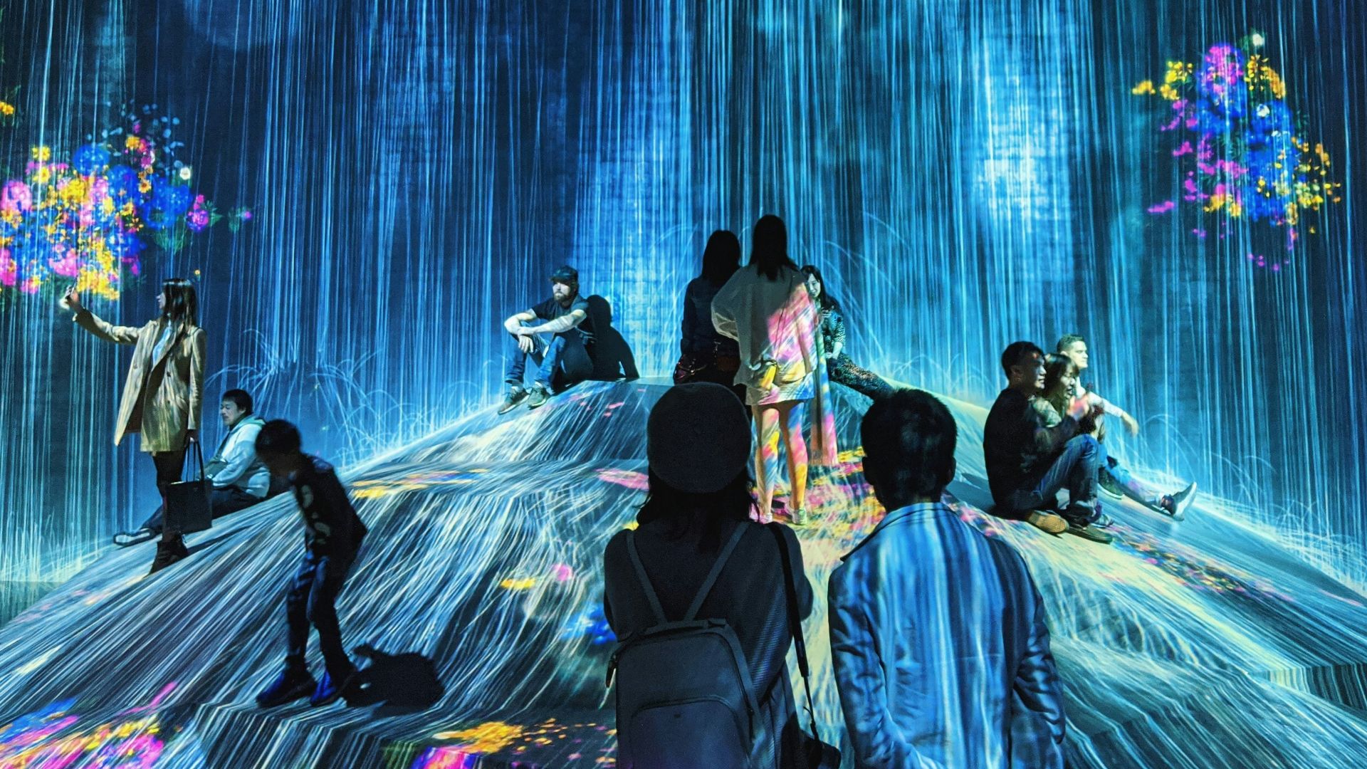 people dancing on stage with blue lights