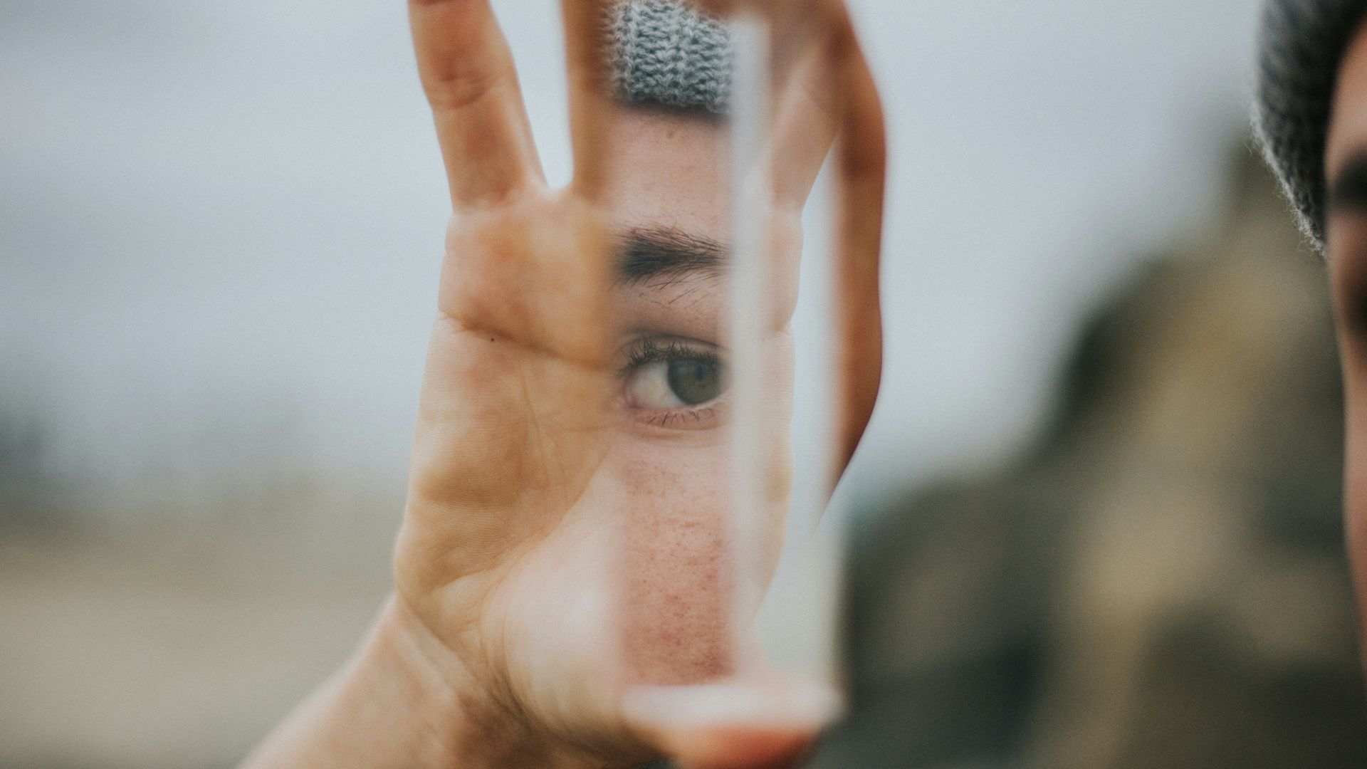 shallow focus of person holding mirror