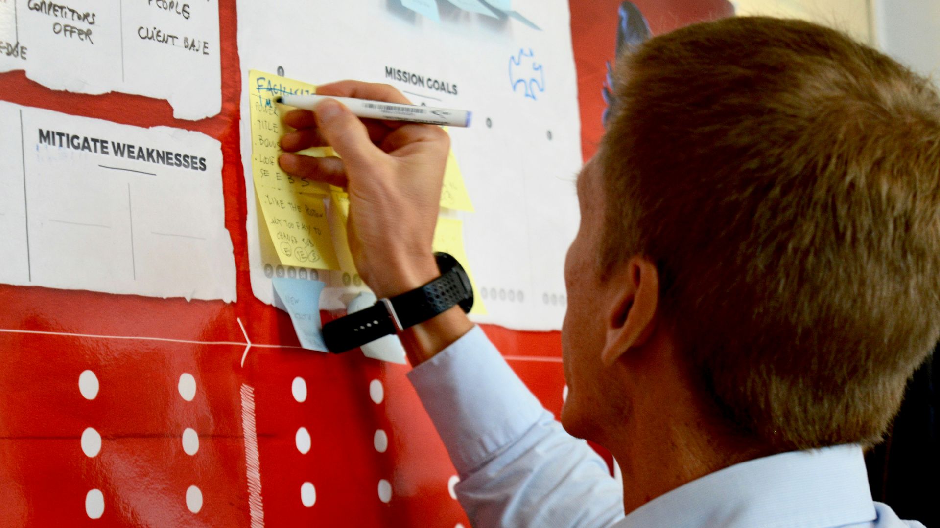 man in white dress shirt holding yellow and white labeled pack