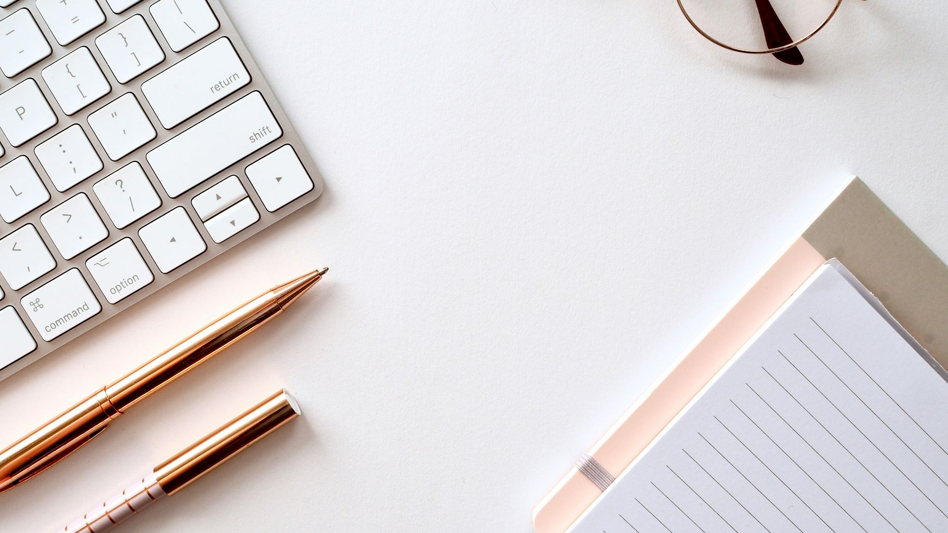 pen near black lined paper and eyeglasses