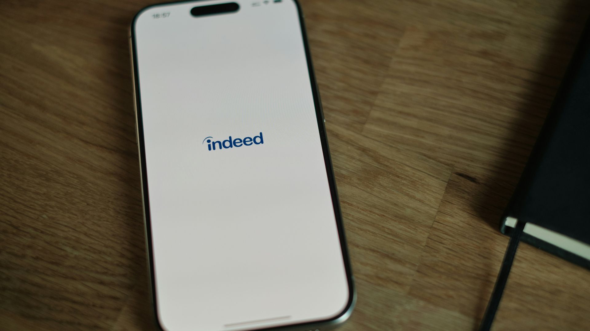 A cell phone sitting on top of a wooden table
