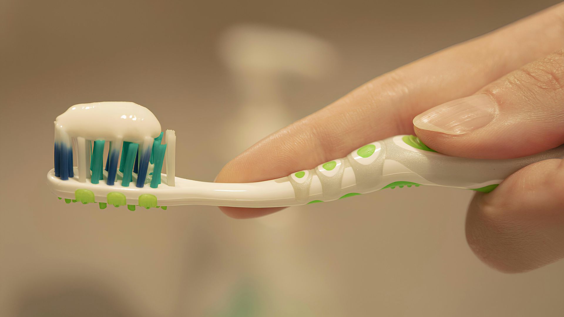 a person is holding a toothbrush with toothpaste on it