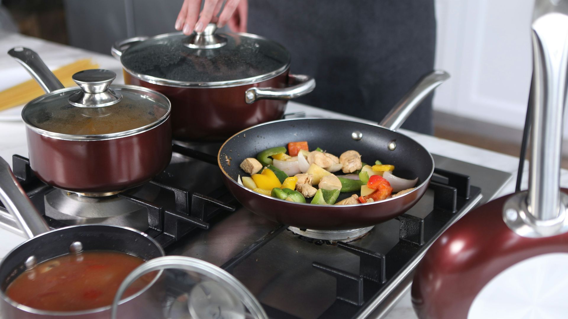 person cooking on stainless steel cooking pot