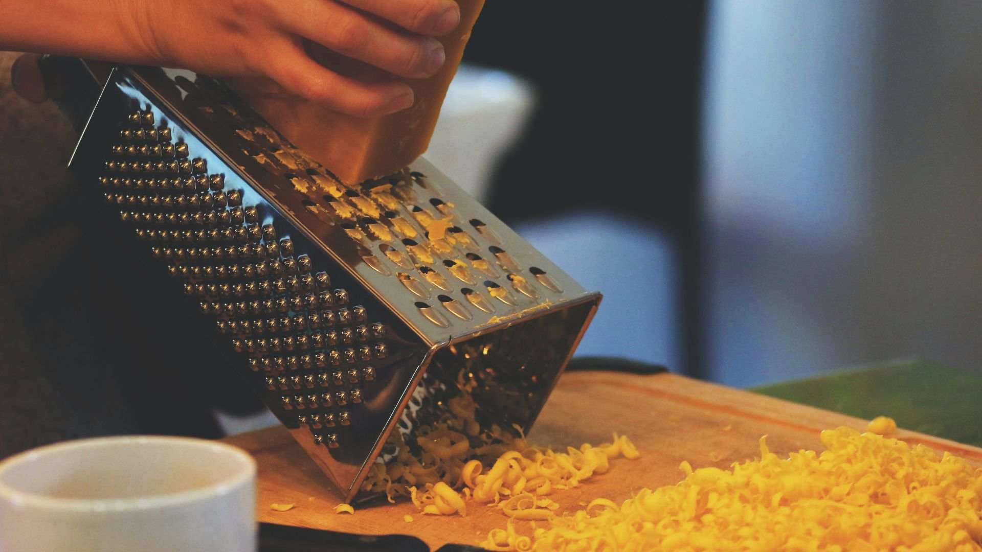 person grating cheese