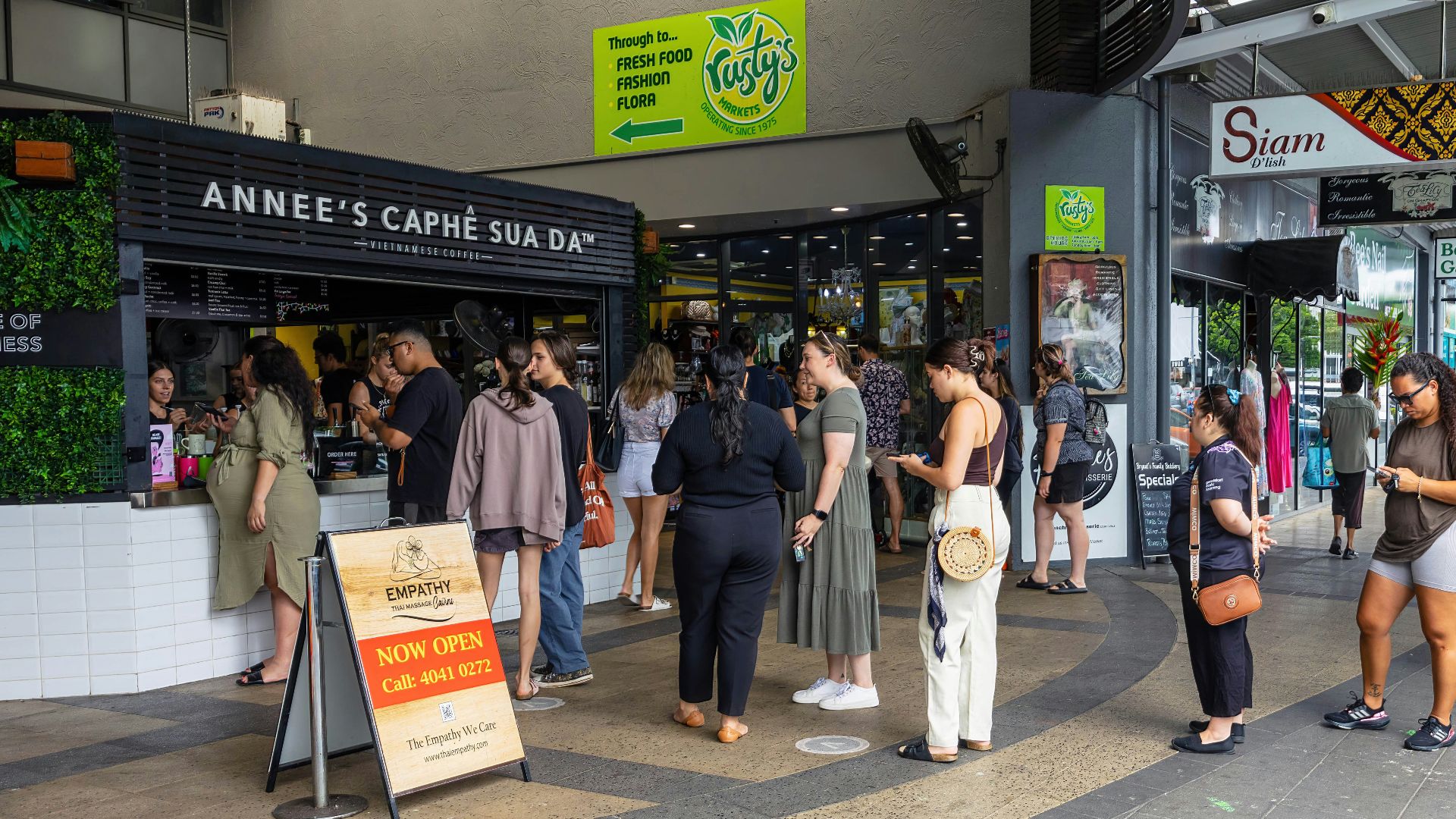 a group of people standing outside of a store