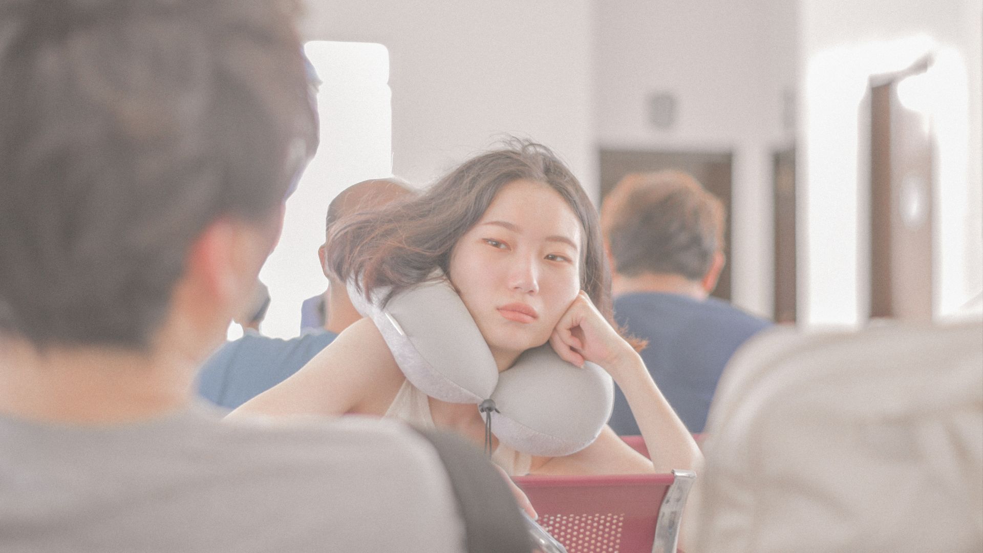 woman in white brassiere sitting on couch