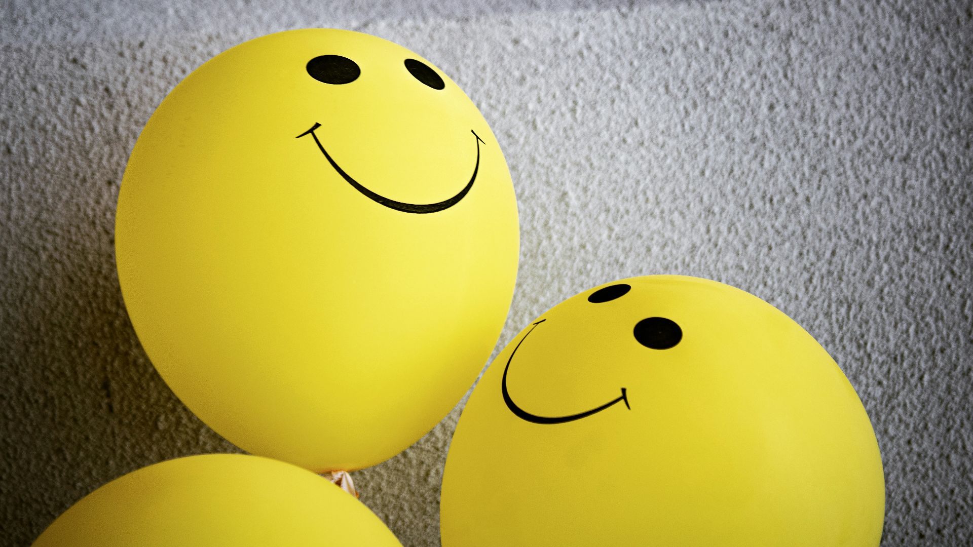 yellow smiley emoji on gray textile