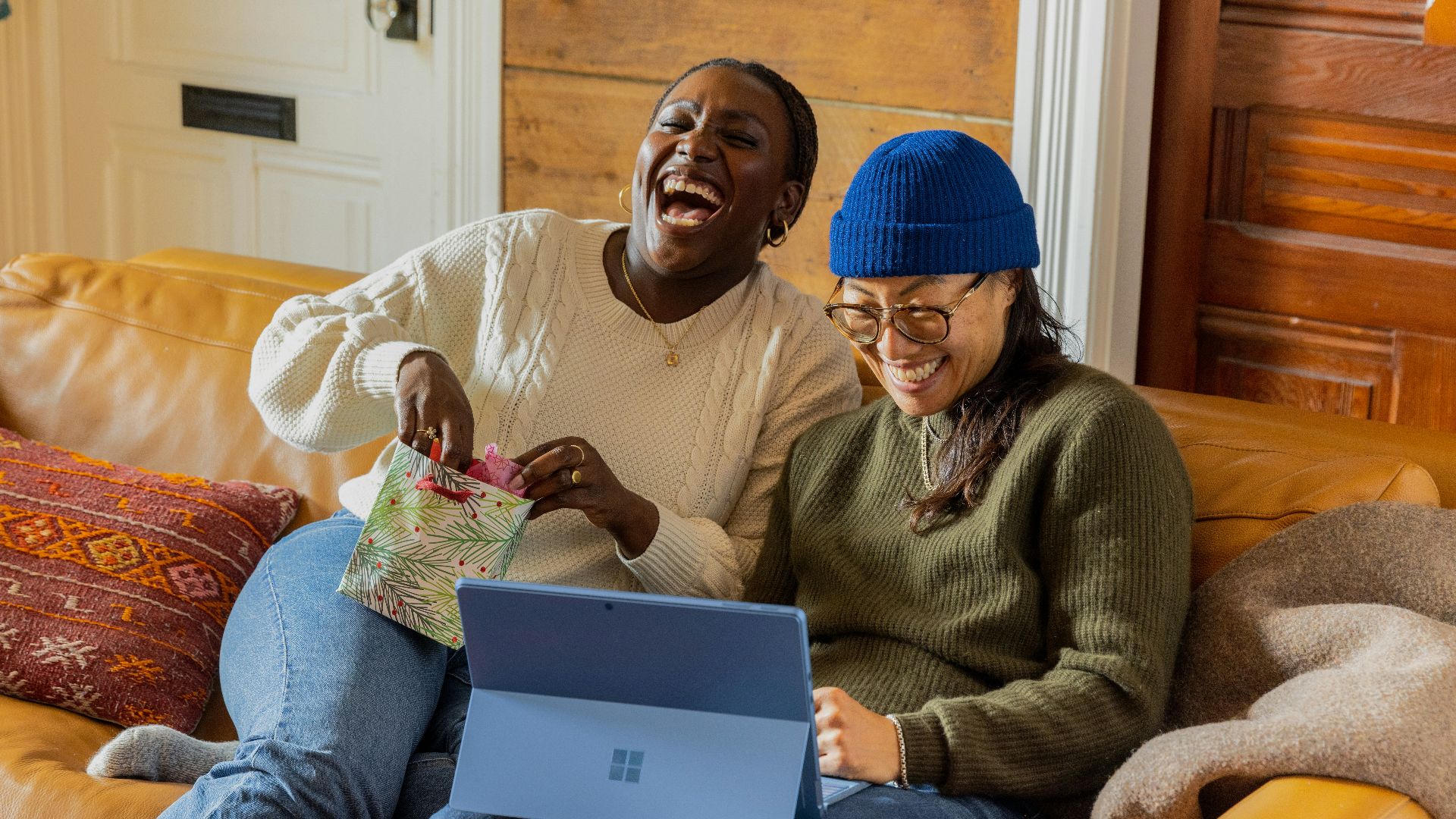 a person sitting on a couch with a laptop