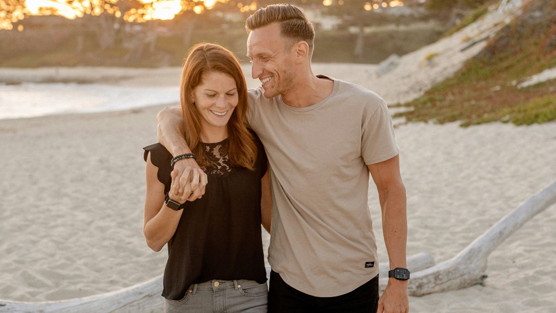 man and woman standing on beach during daytime