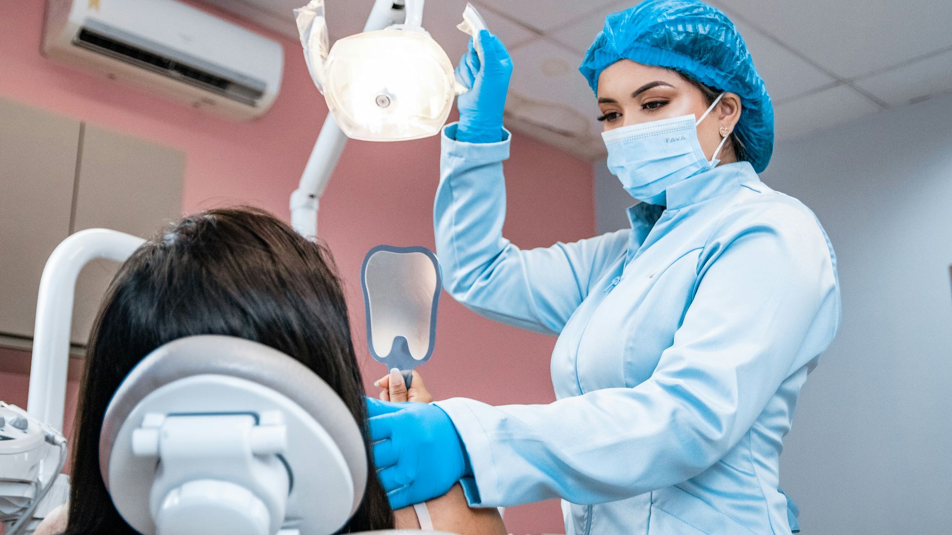 a woman getting her teeth checked by a dentist