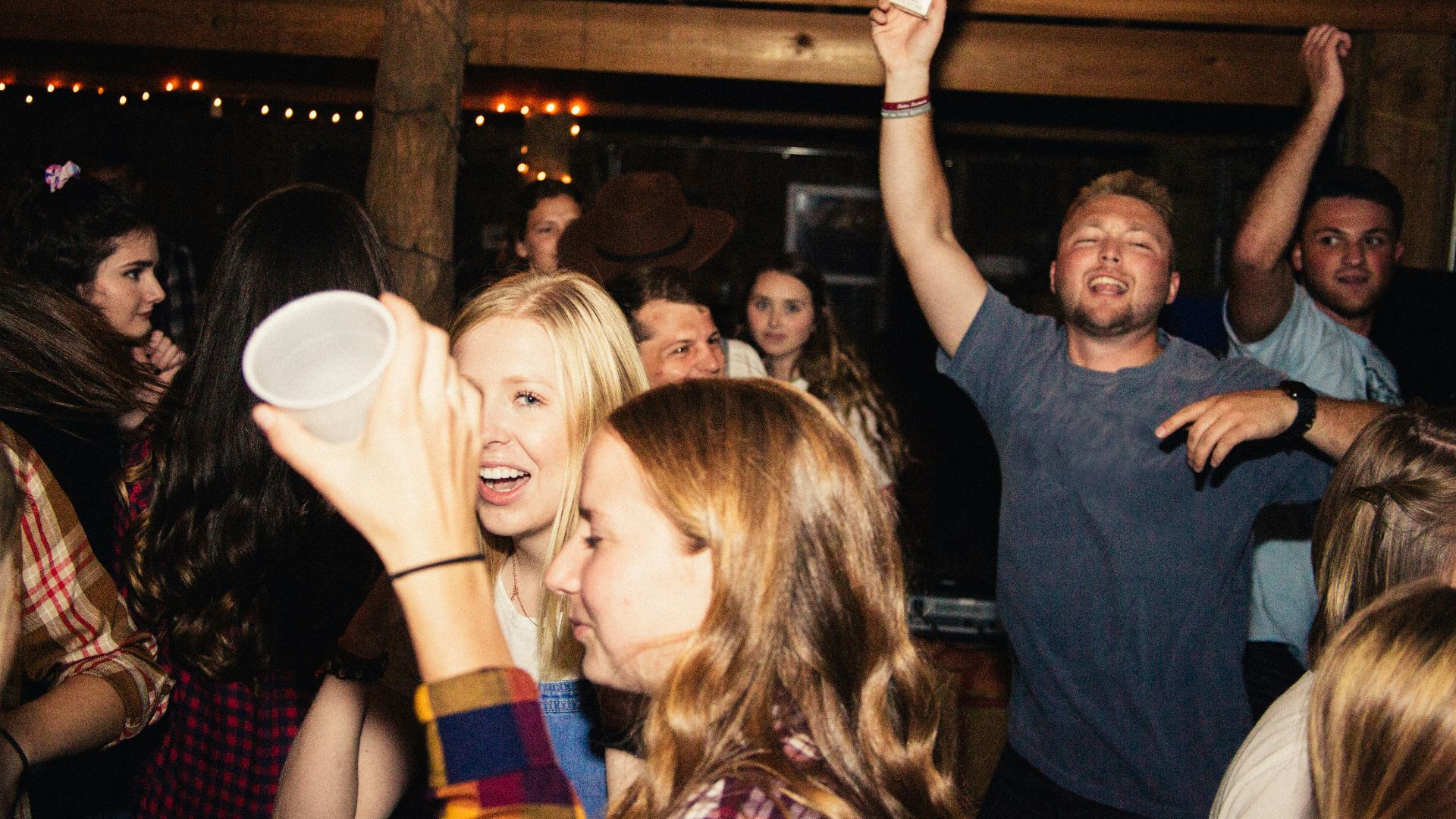 man in black crew neck t-shirt holding white ceramic mug