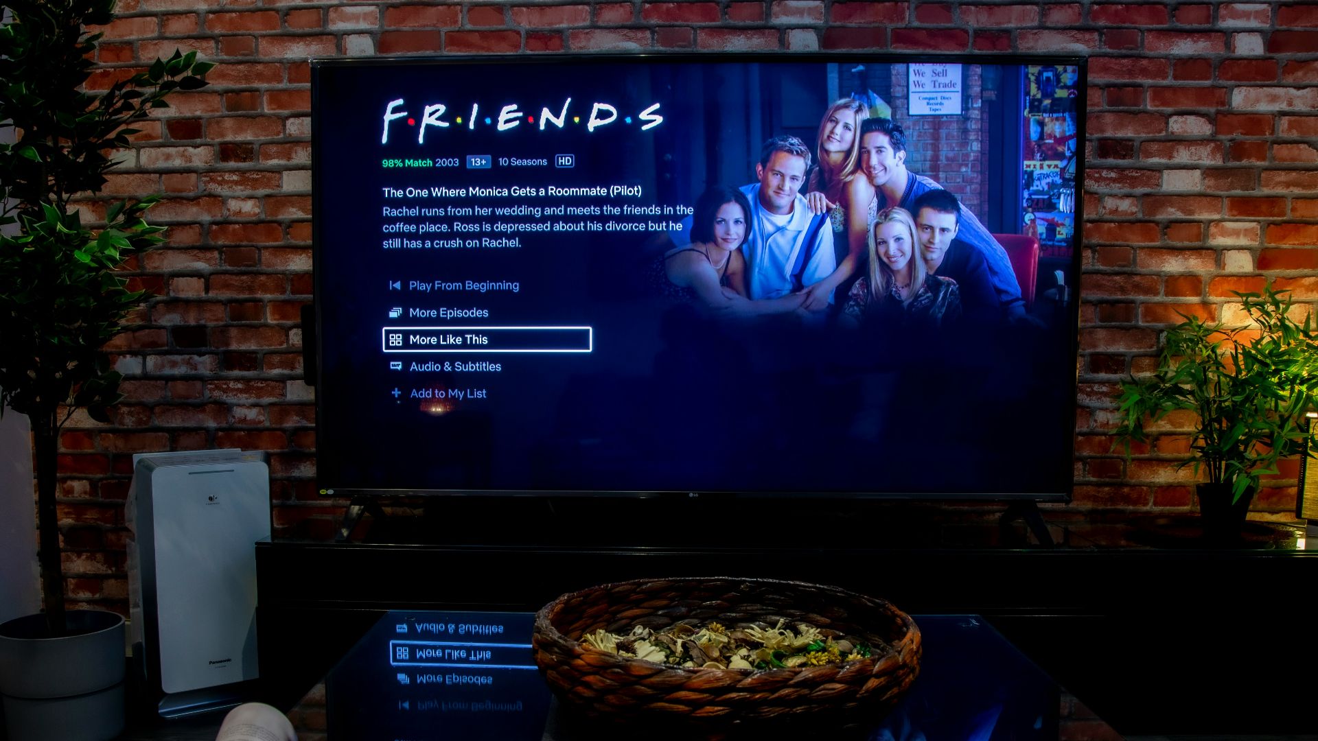 black flat screen tv turned on near brown brick wall