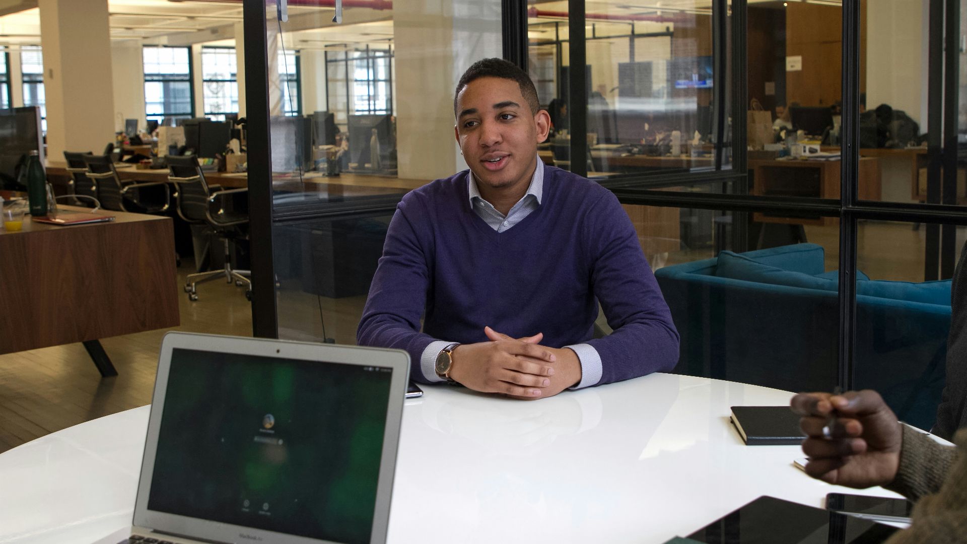 a man sitting at a table with a laptop