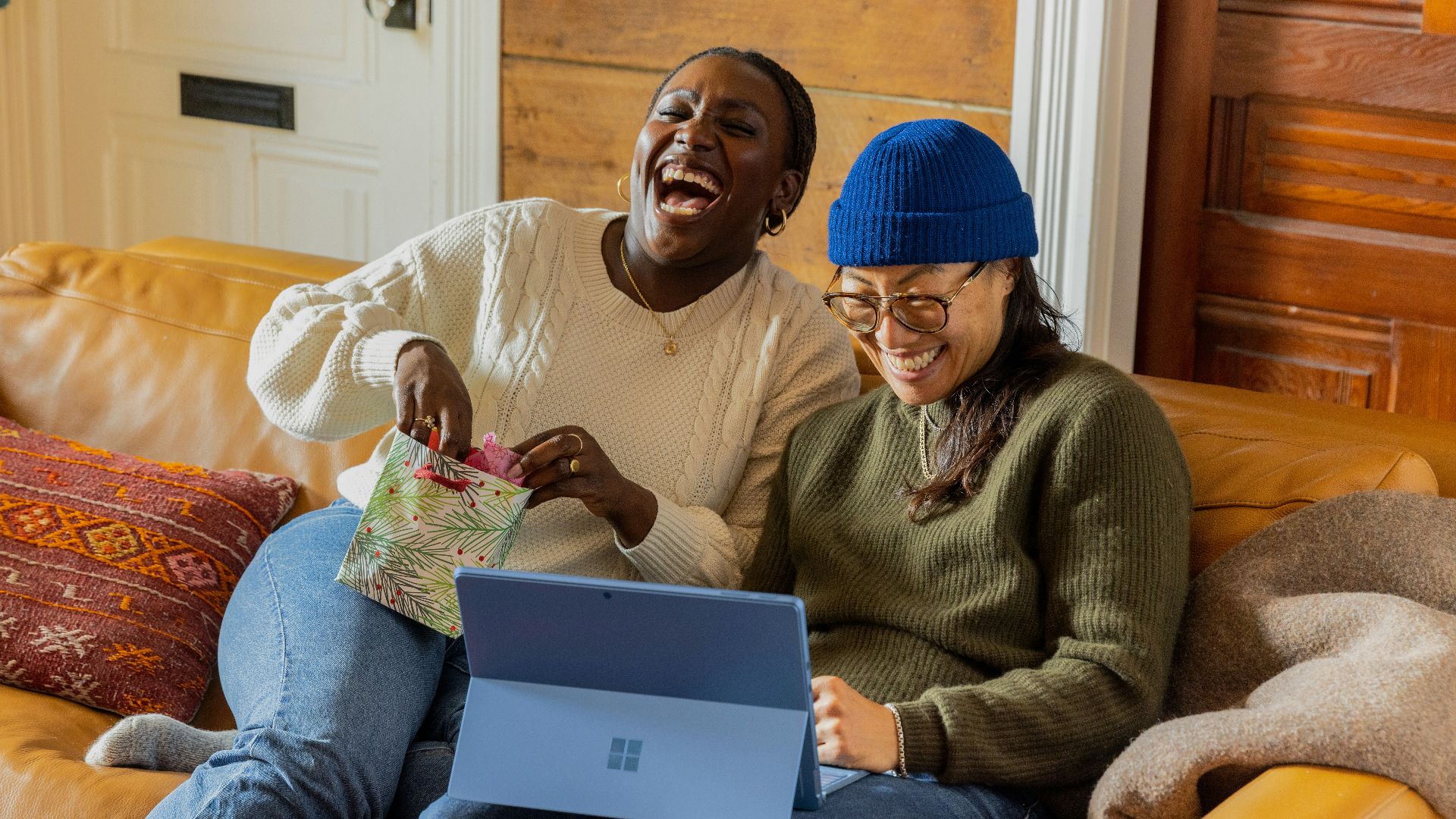 a person sitting on a couch with a laptop
